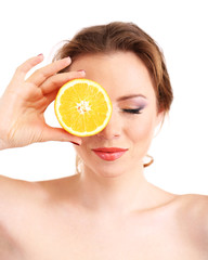 Beautiful young woman with bright make-up, holding orange,