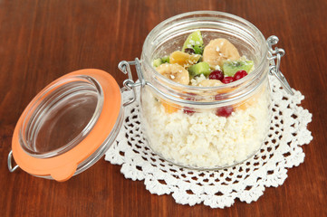 Cottage cheese in glass bottle with exotic fruits,