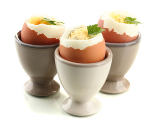 Boiled eggs in egg cup, isolated on white
