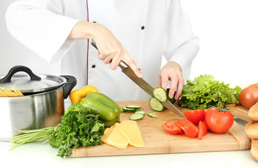 Female hands cutting vegetables, isolated on white