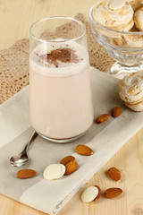 Glass of chocolate-cream cocktail on wooden table close-up