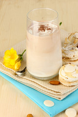 Glass of chocolate-cream cocktail on wooden table close-up