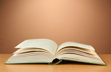 Opened book on color background