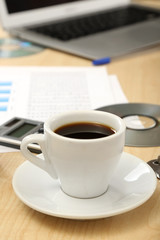 Cup of coffee on office desktop close-up