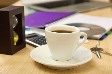 Cup of coffee on office desktop close-up