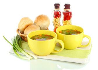 Fragrant soup in cups isolated on white