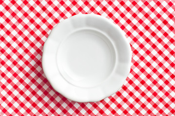 white old plate on checkered napkin