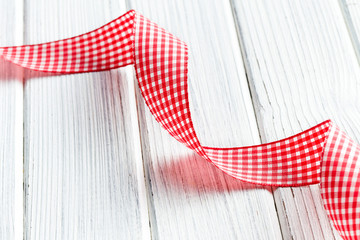 checkered ribbon on white wooden table