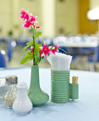 Table set on the restaurant and Vase of flowers
