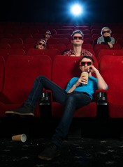 People in 3D glasses watching movie in cinema