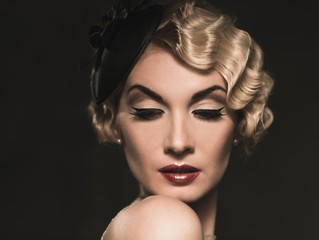 Elegant blond retro woman  wearing little hat
