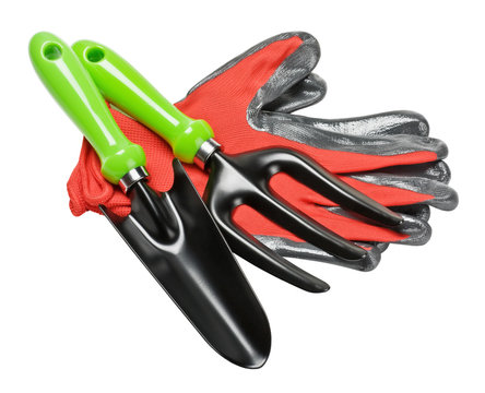 garden tools and red gloves on white background