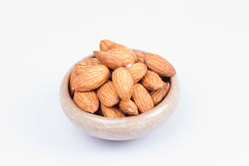 Almonds in bowl isolated on white background