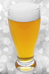 glass of beer over abstract background