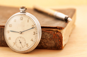 Old clock with vintage book