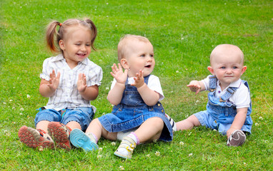 Happy children on a green meadow.