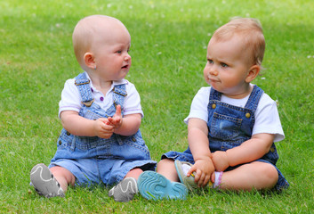 Happy children playing on a green meadow.