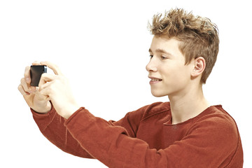 Teen boy photographing with a smartphone