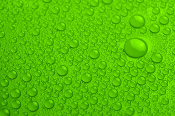 Water drops on green background