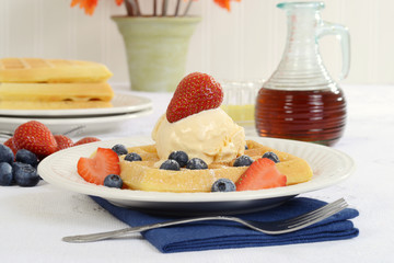 closeup waffles with strawberries blueberries and ice cream