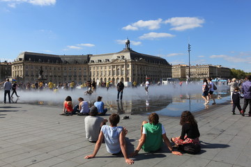 People gathered by a public fountain