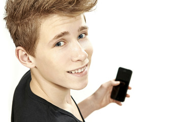 Teenager holding smartphone and smiles