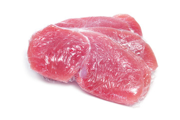 raw turkey meat wrapped in plastic wrap