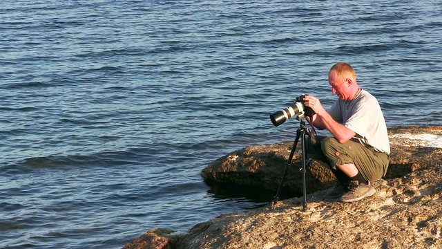 Photographer takes pictures with a tripod