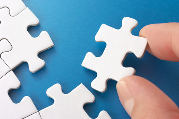 Fototapeta premium A person assembling puzzle pieces.
