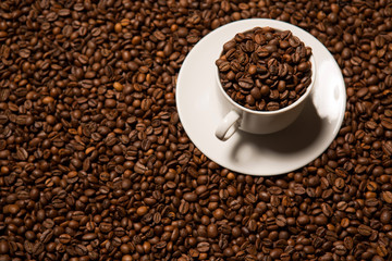 cup with coffee beans on a dark background