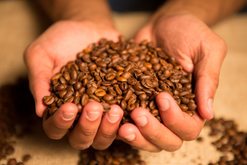 heart of cofee grains in hollow the hand