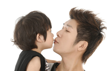 Father kissing his son on the forehead, isolated