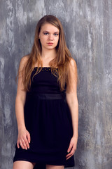 Naklejka premium Beautiful blonde near the wall