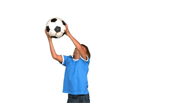 Boy jumping and catching football