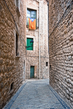 Catalan flags placed on balcony on street in Girona, Spain.