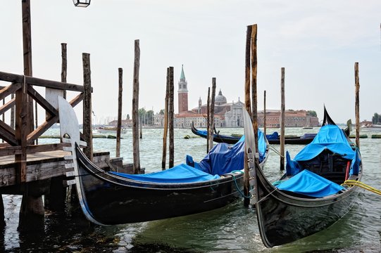 View to the gondolas and boats berth  in Venice.