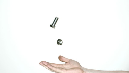 Mans hand tossing screw and bolt - Powered by Adobe