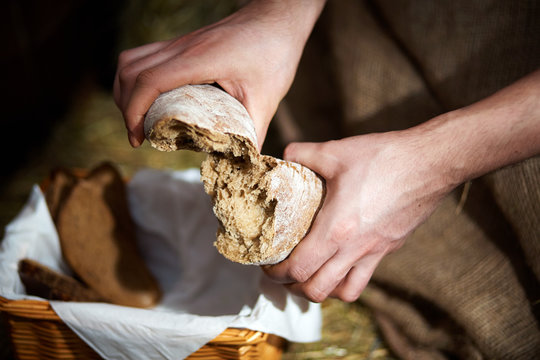 Breaking loaf of bread