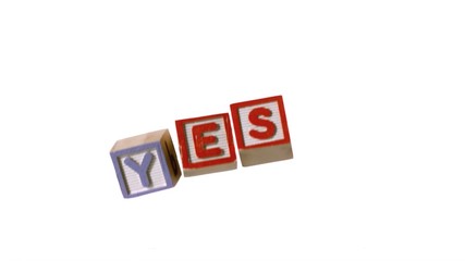 Yes spelled out in letter blocks falling over - Powered by Adobe
