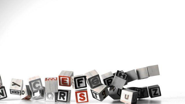 All letters of alphabet blocks falling over