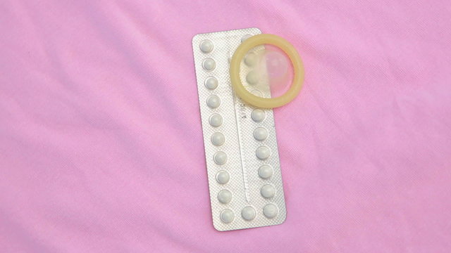 Contraceptive pill packet with condom