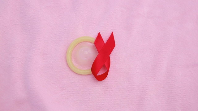 Condom and red ribbon