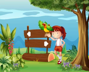 Foto auf Glas Ein Papagei und ein Mädchen neben einem Schild im Wald © GraphicsRF