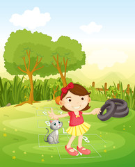 A girl playing at the park with her cat