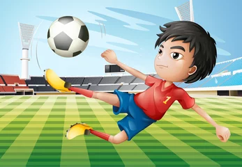 Kussenhoes Een jongen die voetbalt op het voetbalveld © GraphicsRF