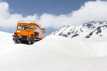 Snow Vehicle in Mountains