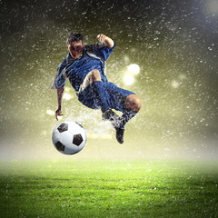 football player striking the ball