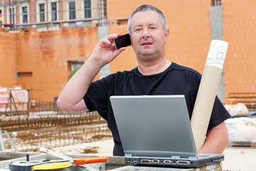 Friendly construction worker with a spirit level