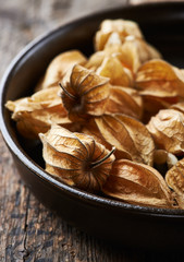 Ripe physalis in a dark ceramic dish