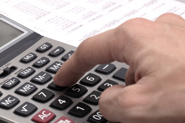 Male businessman using a calculator